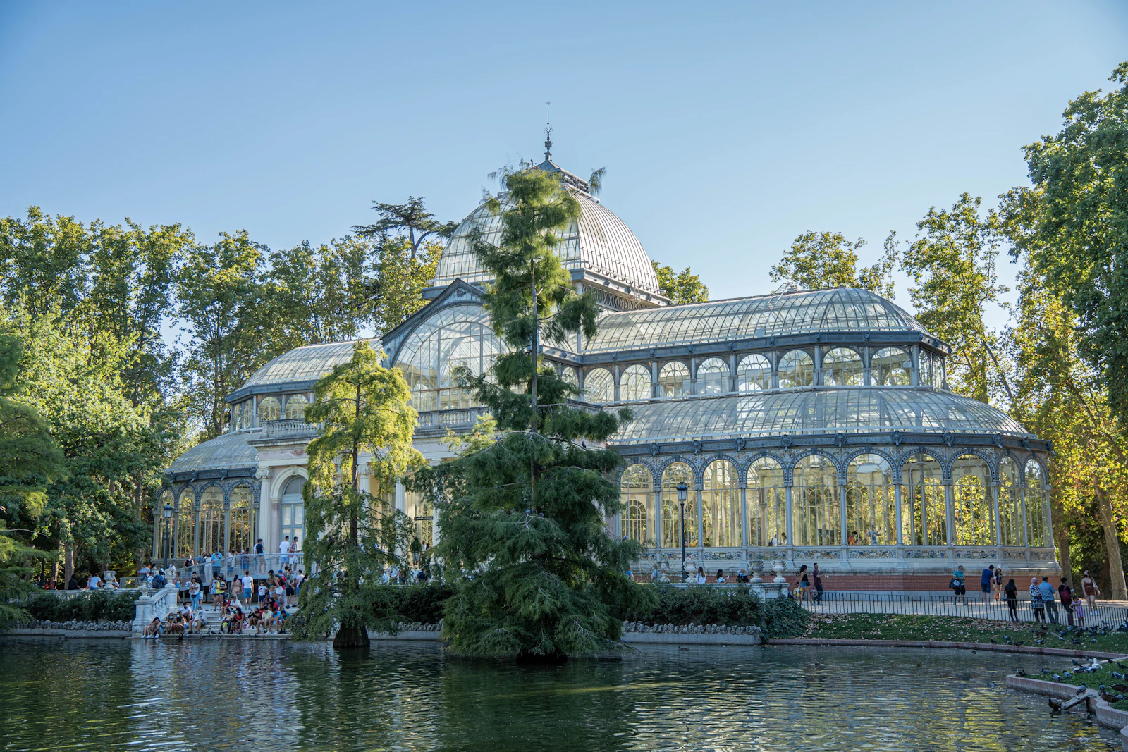 Crystal Palace surrounded by trees and water in Retiro Park, Madrid