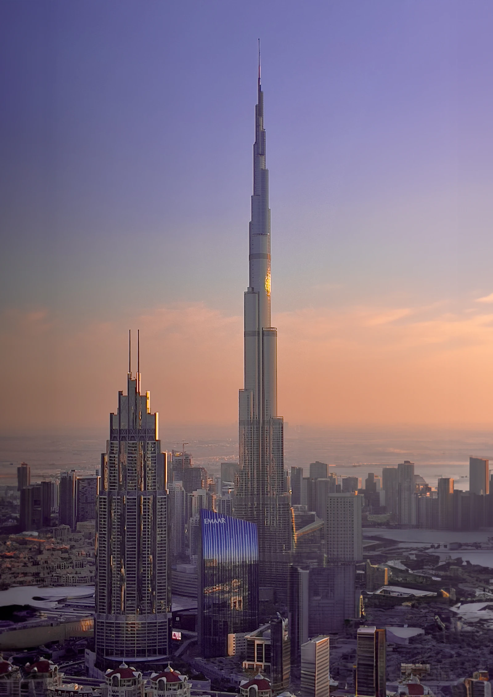 Burj Khalifa towers over the Dubai skyline at sunset