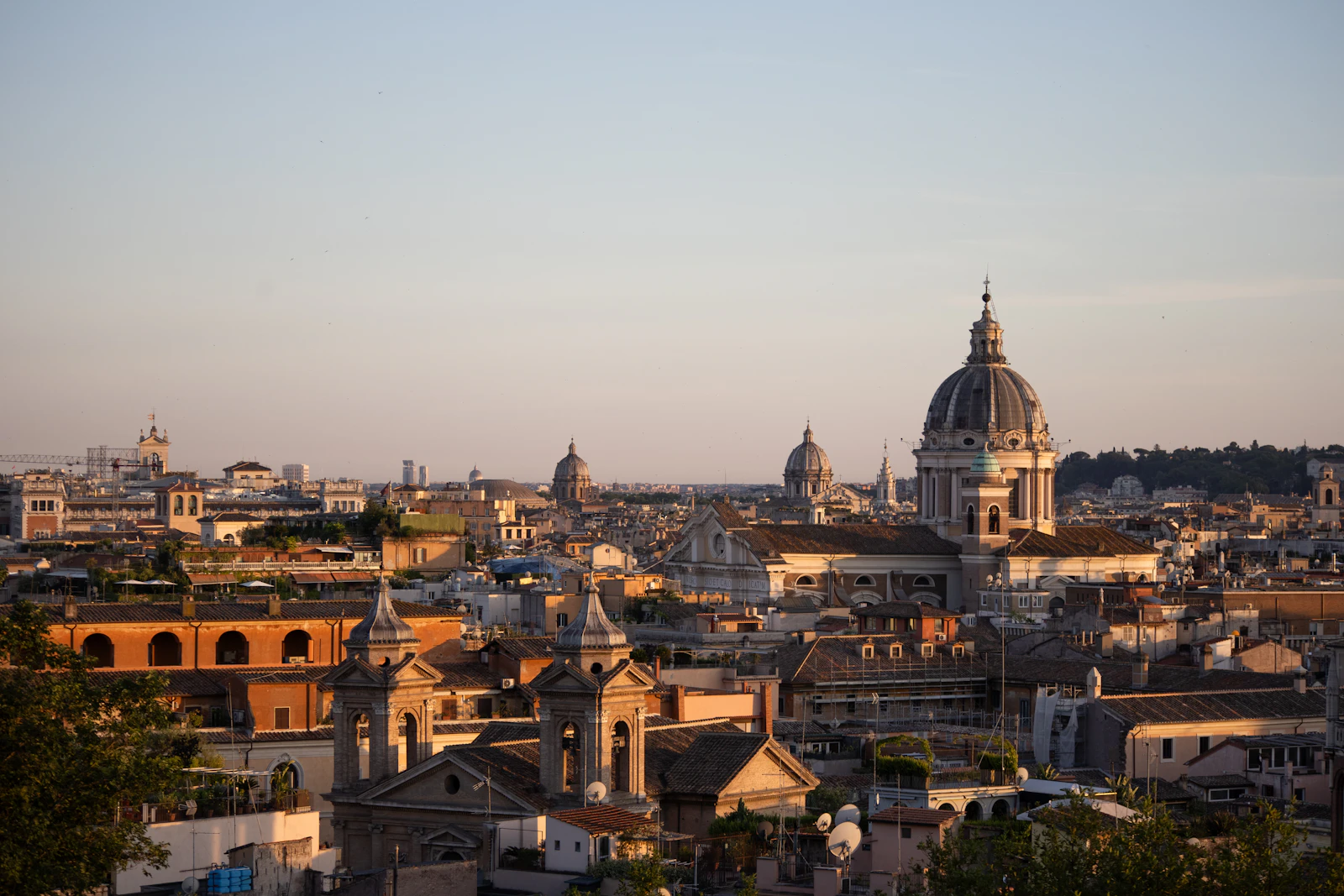 Rome cityscape with domes and bell towers at golden hour